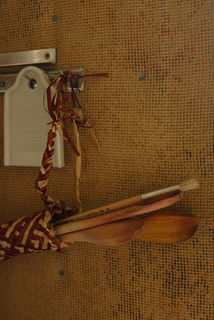 Some of Bronnie's flax weaving hanging on wool carpeted walls awaiting mudbrick surfacing