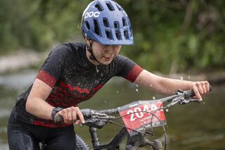 Final river crossing to finish line - Karapoti 50k 2025. Sophia wears women's Tumeke. Pic Neil Kennington