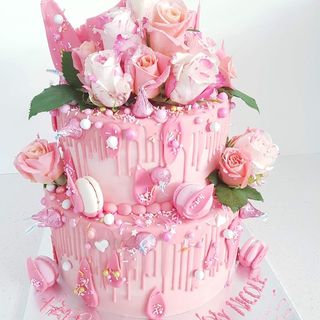 Two tier pink drip cake with pink icing