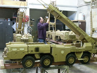 In the workshop Brent Davenport is putting the final touches on one of the scud missile launchers.